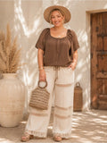 Plus size woman wearing a brown bubble sleeve button-front top